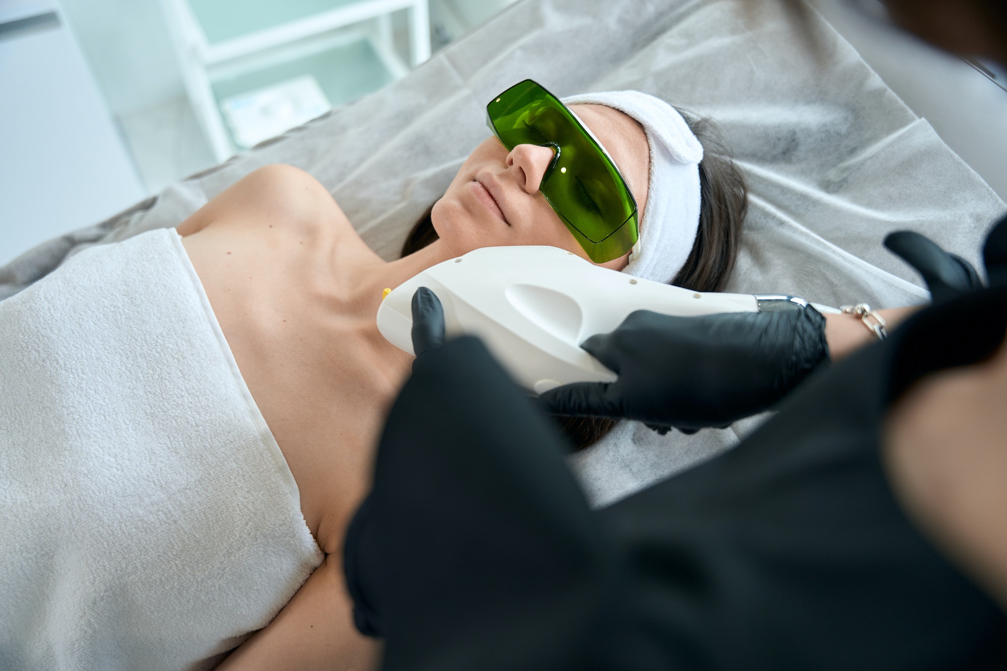 Adult lady on neck laser hair removal procedure