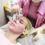 Professional - beautician puts on the skin for the chemical peeling agent with a brush.